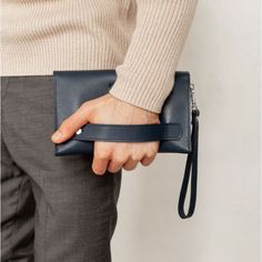 A leather men's clutch is an indispensable item for a modern business man.The accessory is made by hand. Strong genuine leather was used for tailoring.Inside the accessory there are two large compartments and 10 pockets for cards and business cards. There is also a zipper pocket on the front outer wall of the accessory for coins and other small items.The button clutch closes. For convenience, the accessory is equipped with a removable leather loop, which allows you to wear the accessory on the w Men’s Leather Bag, Men’s Purse, Small Man Bags, Leather Bags For Men, Men Purse, Men Clutch Bag, Mens Leather Accessories, Interview Outfits, Purse Ideas