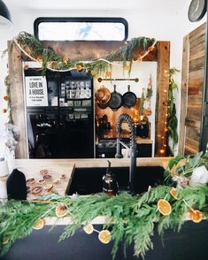 the kitchen is decorated with greenery and lights