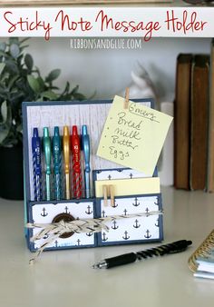 an image of a desk with some pens and markers on it's holder that has notes attached to it