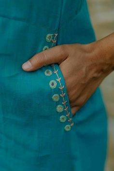 a close up of a person wearing a blue dress