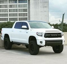 a white toyota truck parked in a parking lot