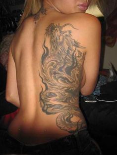 a woman with a dragon tattoo on her back