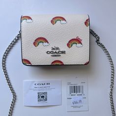 Authentic Brand New With Tags In Original Packaging Including Coach Shipping Plastic And All Protective Materials Limited Edition Pride Collection Coach Mini Wallet On A Chain With Rainbow Print Silver/Chalk Multi Printed Coated Canvas And Smooth Leather Style No. Ck391 Two Credit Card Slots Snap Closure, Fabric Lining Outside Open Pocket Detachable Chain Strap With 23 1/4" Drop For Shoulder Or Crossbody Wear 4" (L) X 3" (H) X 1" (W) Chic White Wallet On Chain For Everyday, Trendy White Wallets For Gifts, Coach White Rectangular Wallet, Trendy White Rectangular Wallet, White Coach Wallet For Gift, Coach Mini Wallet, Coach Mini Purse, Rainbow Purses, Pride Collection