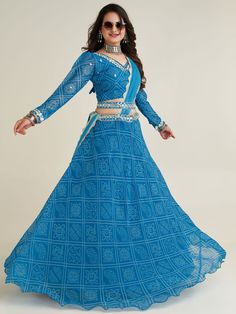 This beautiful sky-blue lehenga is perfect for festivals like Navaratri, special occasions, and weddings. The semi-stitched lehenga comes in a sky-blue color with bandhani print work, intricate thread, paper mirror, and sequin work on the waist.
The set includes a similar color georgette choli with bandhani print work, thread work, paper mirror, and sequins work, as well as a matching georgette dupatta with border work.
This lehenga choli set is its versatility. It can be dressed up for a festiv Sky Blue Lehenga, Navratri Lehenga, Engagement Gown, Lehenga Crop Top, Bandhani Print, Lehenga Choli Wedding, Floral Lehenga, Stitched Lehenga, Party Wear Lehenga Choli