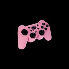 a close up of a pink controller on a black background with no people in it