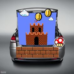 the back end of a car with an image of a nintendo mushroom on it's trunk