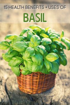 a basket filled with green leaves sitting on top of a wooden table