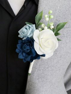 a boutonniere with blue and white flowers on it's lapel