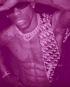 a shirtless man wearing sunglasses and a tie with his hands on his head, posing for the camera