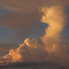 an airplane is flying in the sky with clouds