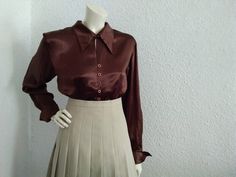 90s satin blouse, brown viscose blouse, french cuffs, 40 size, pointy collar, viscose 48 % and acetat 52% blouse, minimalist spring blouse, simple basic blouse. Measurements laying flat : shoulders :41 cm (16 inches) bust:47cm (18,5 inches) waist :44 cm (17,5 inches) total lenght :54 cm (21 inches) sleeve lenght :66cm (26 inches) Classic Collared Brown Blouse, Classic Brown Blouse For Office, Classic Brown Collared Blouse, Classic Brown Office Blouse, Brown Silk Tops For Workwear, Brown Silk Tops For Work, Brown Silk Workwear Tops, Elegant Brown Tops With Collar, Elegant Brown Collared Tops