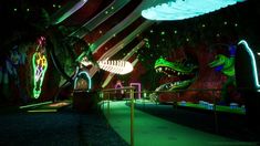 an image of a dinosaur exhibit in the dark with neon lights on it's walls