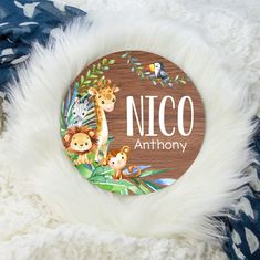 an animal themed wooden name plate for a baby's nursery