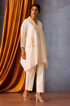 Off white asymmetric tunic featuring sequin flower patch embroidery and a V neck. Paired with side stripe pants made from Chanderi fabric., Fit: Relaxed Side Stripe Pants, Asymmetric Tunic, Sequin Flower, Floral Patches, Stripe Pants, Patch Embroidery, Flower Patch, Pant Sets, Side Stripe