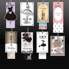 many different tags hanging from strings on a black wall with polka dots and pink flowers