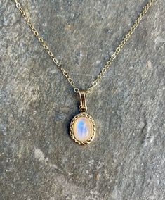 This necklace is handcrafted with an authentic 6x8mm moonstone in a gold setting. The stone is AAA quality with nice flash. The chain is 14k gold-filled and will not tarnish easily.  This necklace is hypoallergenic. (Cadium free, lead free, and nickel safe) Moonstone enhances intuition and connection with the devine feminine.  The necklace comes in a hand-wrapped gift box, ready to be gifted. If you would like to leave a note, you can do so during checkout. Please note that each stone is unique Gold Gemstone Necklace With Moonstone, Gold Moonstone Necklace With Gemstone, Gold Moonstone Gemstone Necklace, Gold Opal Necklace With Cabochon, Gold Moonstone Necklace With Adjustable Chain, Gold Opal Necklace With Oval Cabochon, Dainty Gold Moonstone Jewelry, Gold Opal Necklace With Natural Stones, Oval Moonstone Necklace In Yellow Gold