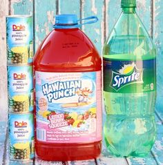 two bottles of hawaiian punch next to each other on a wooden table with blue and white background