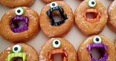 there are many donuts with fake eyes and mouths in the shape of monsters on them