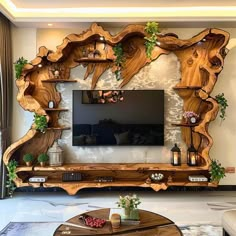 a living room filled with furniture and a flat screen tv on top of a wooden table