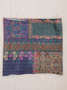 a multicolored patchwork cloth hanging on a wall