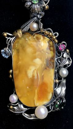 "ARTISAN AMBER GEMSTONE PENDANT Hand-made Sterling Silver 925. 24k Gold Stones used: Butterscotch Baltic Amber Pink&Green Tourmaline, Pearls Height - 2 3/4' (with bail), Width - 1 3/8' Height -70mm (with bail), Width - 35mm Unique Handcrafted One-of a-kind Design Pendant Each Piece of Jewelry in my Collection is Absolutely One of a Kind! When you start wearing a piece of my jewelry you will fall in love with it more and more each day and feel that good Energy and Love that I pass into it whi Luxury Yellow Multi-stone Jewelry, Gold Multi-stone Gemstones, Unique Multi-stone Gold Gemstones, Formal Yellow Multi-stone Jewelry, Unique Polished Gemstones For Formal Occasions, Unique Oval Gold Gemstones, Unique Yellow Gold Brooches With Gemstone, Unique Formal Polished Gemstones, Unique Formal Gemstones With Polished Finish