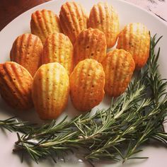 small biscuits and rosemary sprigs on a white plate