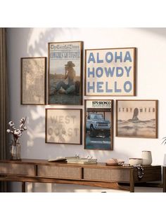 a living room with pictures on the wall and posters above it that say aloha, howdy, hello