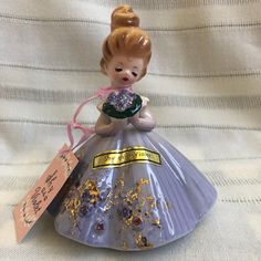 * * * * * FREE SHIPPING * * * * *  ITEM:  BEAUTIFUL JOSEF ORIGINALS Porcelain Girl Figurine, "Shy as a Violet" with Tag and Stickers;   CREATED IN:  1960s; MADE IN:  Japan; SIZE:  About 3.5" Tall; VINTAGE CONDITION:  MINT (NO crazing, cracks, chips, breaks, or repairs).  This doll comes with a Josef Originals 1960s box.  Read story below about my grandpa.  Since my grandpa (the salesman) opened all the Josefs at once to display at Sales Conventions, most all the dolls were put back in the wrong Josef Original box for quick packing;  To see other JOSEF ORIGINALS DOLLS, click on: https://www.etsy.com/shop/MidcenturyCeramicsCo?ref=seller-platform-mcnav&section_id=45179551 My grandpa was a traveling salesman in the western United States during the 1940s-1970s.  He sold wholesale to retailers w Josef Originals, Read Story, Moving Boxes, Original Dolls, Ceramic Figures, Corrugated Box, Butcher Paper, Miniature Art, 1960s Vintage