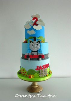 a thomas the train birthday cake on a stand