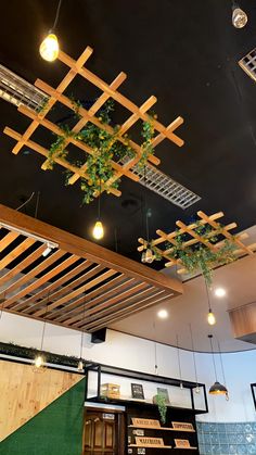 the ceiling is decorated with wooden slats and hanging plants