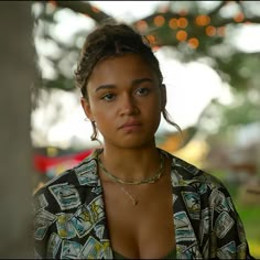 a close up of a person wearing a shirt and necklace with an earring on