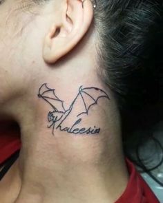 a woman with a tattoo on her neck has the word valesia written in cursive writing