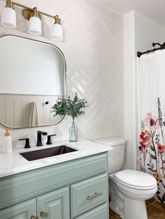 a bathroom with a sink, toilet and mirror