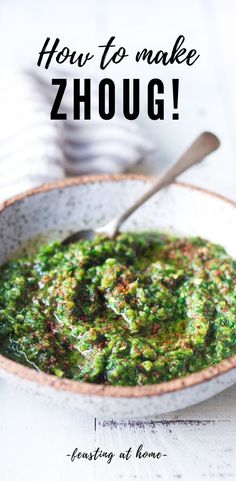 a white bowl filled with green sauce on top of a table