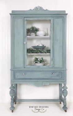 an old china cabinet painted blue with white trim