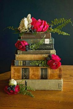 three books stacked on top of each other with flowers