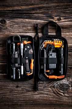 an open tool bag on top of a wooden table filled with tools and gadgets