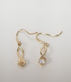 "Thanks for shopping our vintage estate store. We tend to sell well below wholesale and truly hope you enjoy all of our items. Many of the items are one of a kind, so please enjoy scrolling through the pictures and hopefully something will catch your eye. Brown spots are from camera or reflections. Beautiful estate 14k yellow gold dangle earrings with .20ct round cz diamonds. Length: 3/4\" Width: 3mm 1/8\" Weight: .70 gram Gems: 3mm by 2mm .10ct per earring Marked 14k and backs are included." Gold Teardrop Diamond Earrings For Anniversary, Classic Gold Teardrop Diamond Earrings, Vintage Gold Diamond Cut Earrings, Classic Gold Diamond Earrings With Birthstone, Gold Teardrop Diamond Earrings For Gift, Gold Diamond Earrings With Birthstone For Formal Occasions, Classic Birthstone Diamond Earrings For Anniversary, Classic Diamond Birthstone Earrings For Anniversary, Gold Diamond Birthstone Earrings For Anniversary