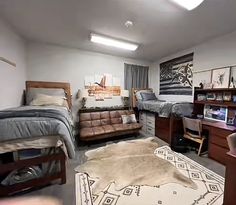 a bedroom with two beds, a desk and a chair