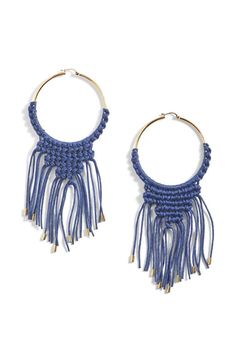 a pair of hoop earrings with fringes and beads on the ends, in blue