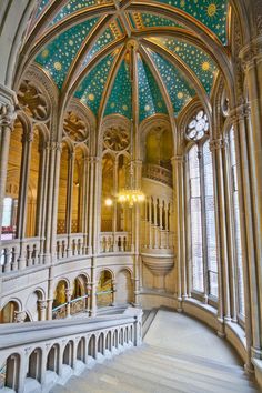 the inside of a building with an ornate ceiling and chandelier in front of it