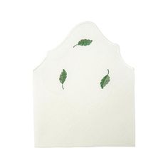 a white paper napkin with green leaves on the front and back of it, against a white background