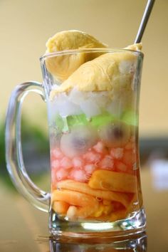 a glass mug filled with fruit and vegetables