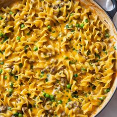 a skillet filled with pasta and peas