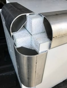 an aluminum pipe with some white paper sticking out of it