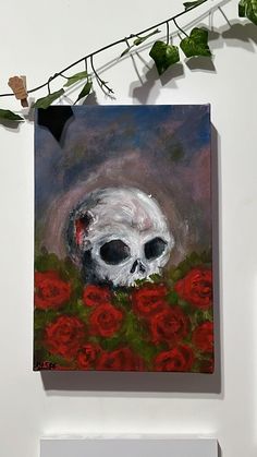 an acrylic painting of a skull sitting in a field of red roses on a white wall