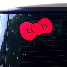 a red sticker on the side of a car with two boxing gloves sticking out of it