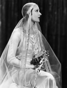 an old photo of a woman wearing a veil