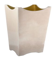 a white vase with gold trim on it