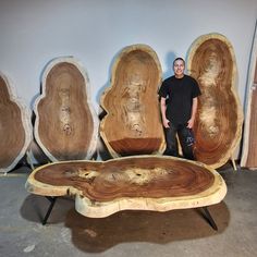 a man standing in front of some wood pieces